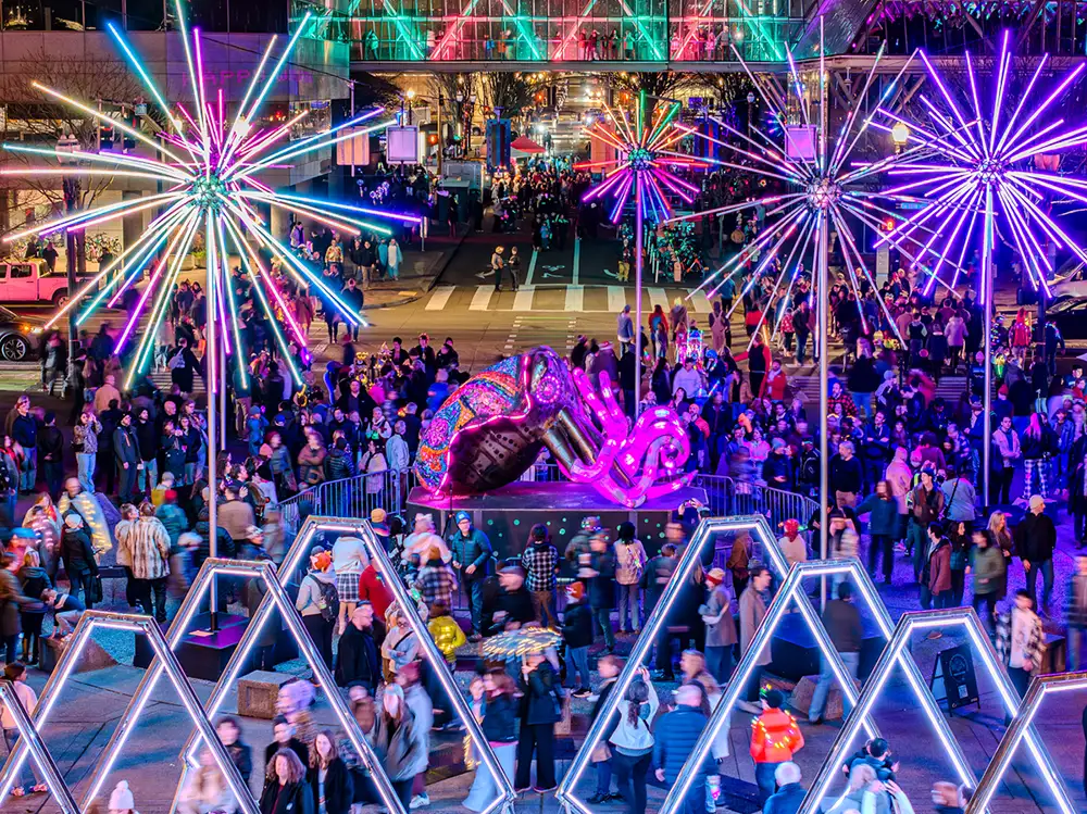 Glowing installation are in a crowded downtown city at night